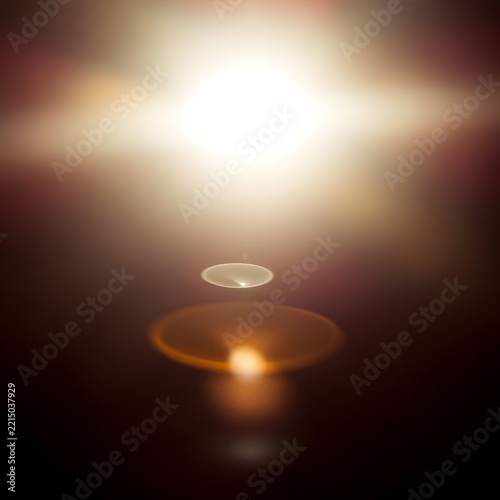 Bright Golden Lens Flare Light Effect on Dark Atmospheric Background