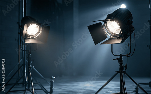 Film production and creative lighting, professional studio equipment with bright spotlights for photography and video broadcast in dark production environment