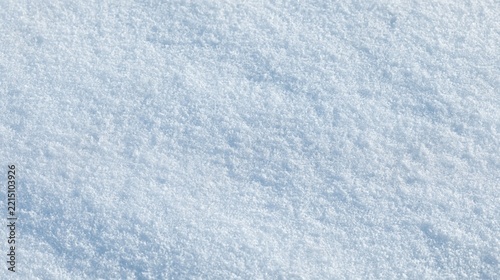 Close up top down view of fresh undisturbed bright white snow texture on a winter day