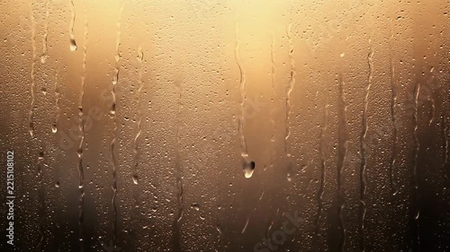 Condensation Droplets Sliding Down Fogged Glass Background