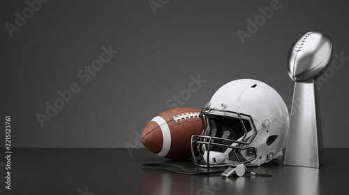 White sports helmet leather ball silver championship trophy and referee whistle on dark surface