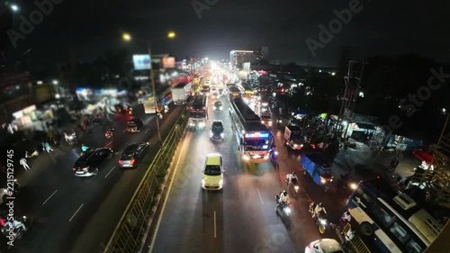 Busy Night Indian Road Traffic and Street Lights in Bhubaneswar, Odisha, India. Indian City Road Traffic at Night with Vehicles, Buses, and Motorcycles Under Streetlights. 