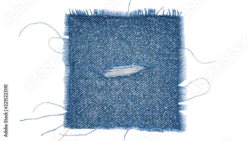 Square blue denim fabric swatch with frayed edges and a central rip, isolated on transparent background