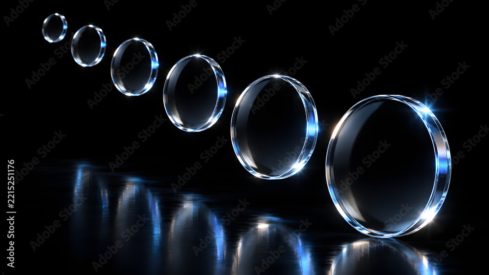 Fototapeta premium Row of glowing glass rings with blue light reflections on glossy black background in diminishing perspective