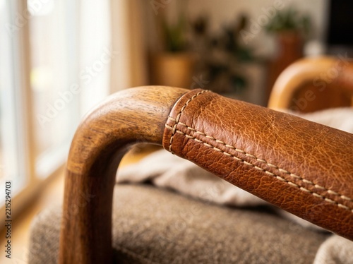 Wooden armchair armrest detail with leather upholstery and visible stitching for home decor