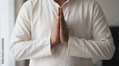 Hands joined in namaste greeting, South Asian respectful gesture, cropped at the chest