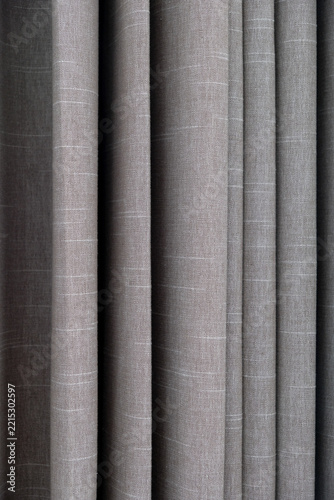 Brown fabric curtains texture with neat vertical folds