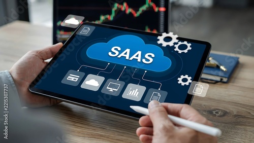 Person using digital tablet displaying SaaS cloud computing and data management system
