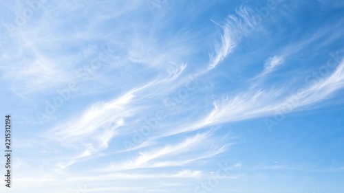 Wispy Cirrus Clouds in Azure Sky: Delicate, feathery cirrus clouds drift across a vast expanse of clear blue sky, painting a serene and ethereal masterpiece.