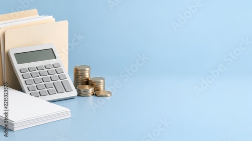 White calculator with folders and coin stacks against a pale blue background