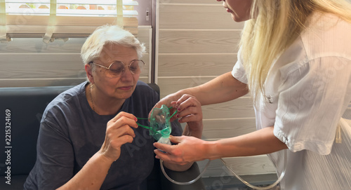 Doctor providing a nebulizer and mask to a patient for asthma and COPD treatment