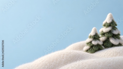 Two felt evergreen trees in plush ivory snow against a pale blue background