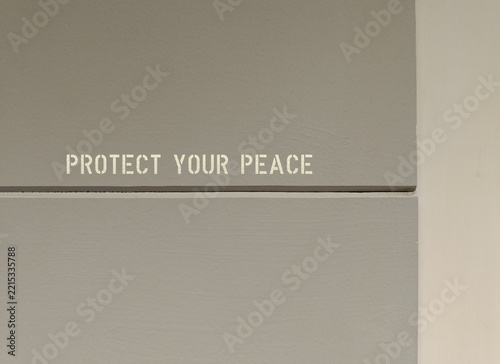 Wall with text written PROTECT YOUR PEACE, to get real about negative things that affect you and take action to reduce them from life