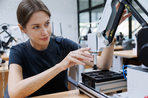 Female automation machine engineer student study and inspection control robot machine in university workshop. ai robot technology new innovation trend of manufacturing in industry 5.0