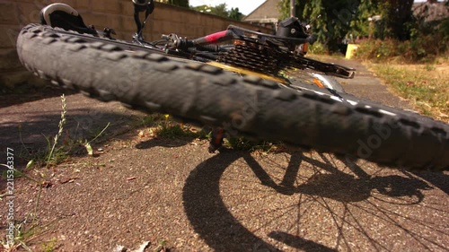 Stationary bicycle wheel turning on pathway