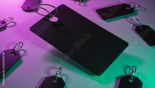 black price tags floating in the air with vibrant neon lighting creating a modern shopping concept video