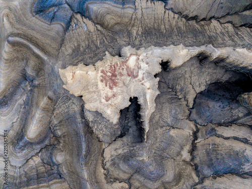 Aerial view of eroded desert rock formations with intricate geological textures and patterns in the arid landscape of Hanksville, Utah, United States.