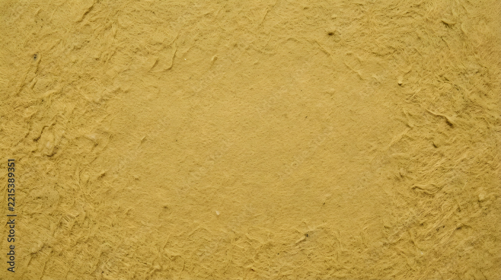 Fototapeta premium Textured yellow straw paper background with visible fibers paper texture fibrous texture craft paper recycled paper rough surface vintage paper handcrafted paper material organic textur
