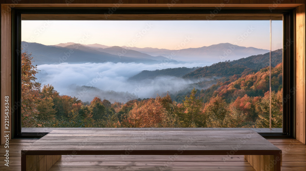 Naklejka premium panoramic window view of mountain landscape covered with autumn fog sea of clouds bright fall forest trees and low wooden table in cozy modern cabin room peaceful scenic morning view