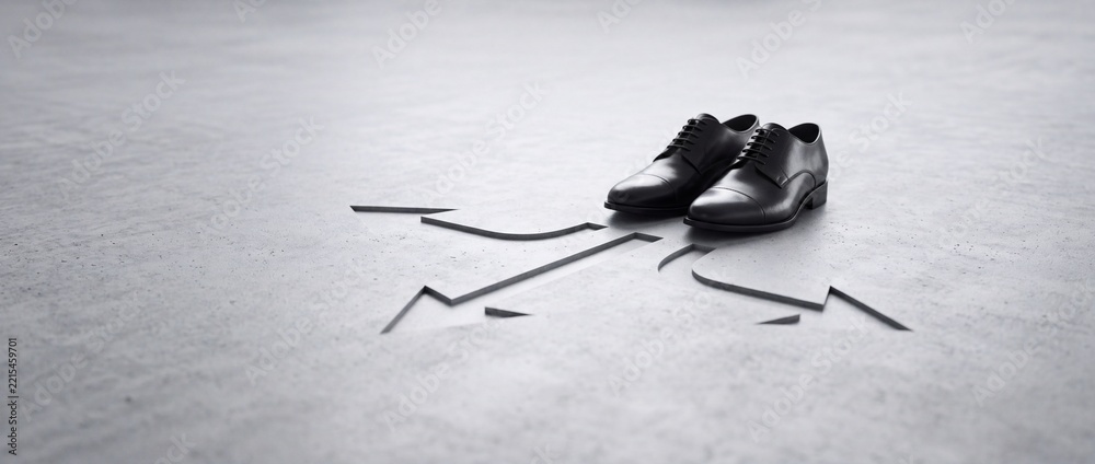 Fototapeta premium Conceptual image of a pair of black leather business shoes standing at a crossroads with multiple directional arrows carved into a concrete floor, symbolizing career choices and decision making.
