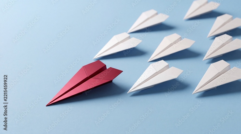 Fototapeta premium Red Paper Plane Leading a Fleet of White Paper Airplanes on a Blue Background, Symbolizing Leadership, Success, Unique Business Strategy, Innovation, and Being the Top Choice in Industry