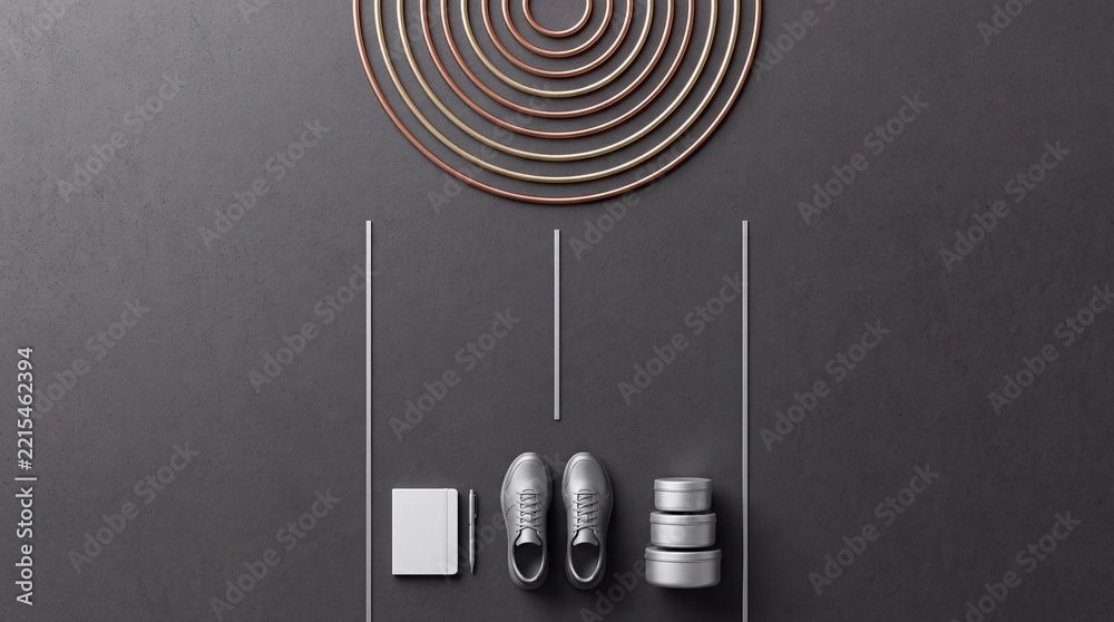 Fototapeta premium Minimalist Top Down View of Modern Essentials Including Silver Sneakers White Notebook Pen and Stacked Metal Tins Arranged Neatly with Golden Concentric Circles on a Dark Textured Background