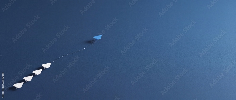 Fototapeta premium Blue Paper Airplane Changing Direction and Leading White Ones on Navy Blue Background, Concept of Leadership, Innovation, Business Strategy and Thinking Outside the Box with Wide Copy Space