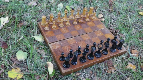 Chess game setup on grass in an outdoor setting