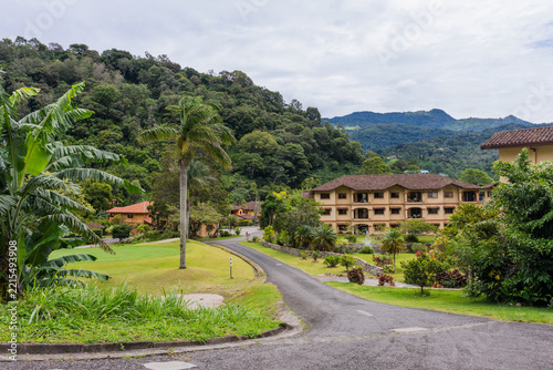 Residential community in Boquete, Panama, on a cloudy day with green forested mountain backdrop.
