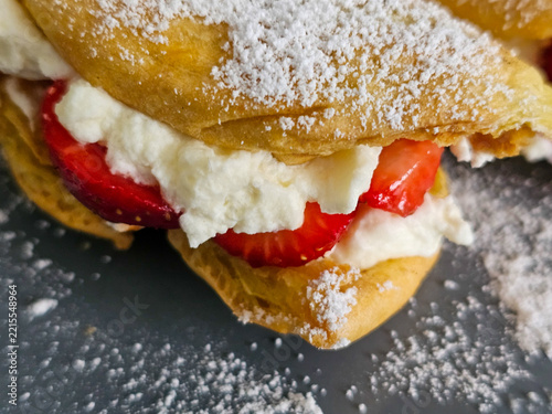 Cream puffs filled with whipped cream and strawberries