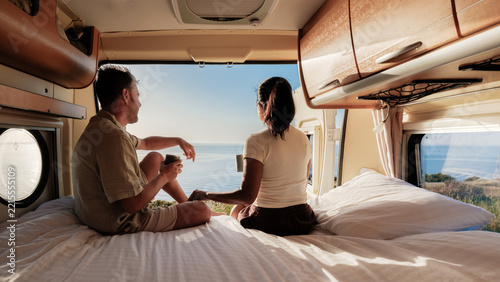 Couple enjoying a serene morning view from their camper in Chalkidiki, Greece