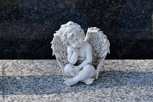 sweet dreaming angel figure on a grave