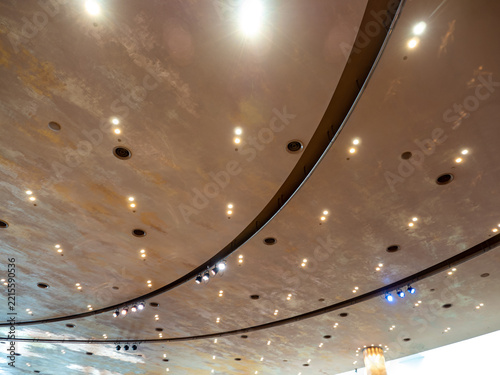 Decorative lights are arranged neatly on the ceiling of the large building