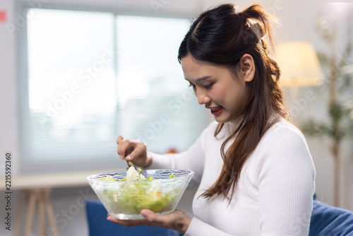Obraz na plátně Woman showing dislike for eating healthy salad