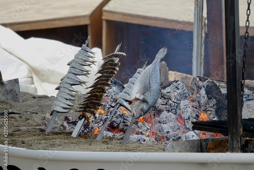 Grilled Fish on Skewers Over Open Fire