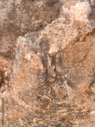 Natural brown stone texture background, rough rock surface close up