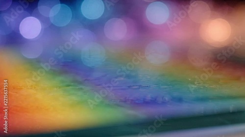 Vibrant rainbow color gradient background with glowing bokeh light effects in motion video clip