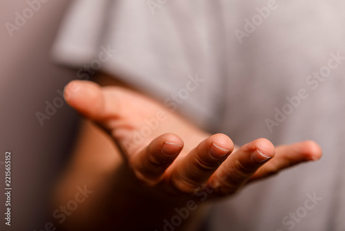 The human hand is open and extended, symbolizing offering, receiving, or showing.