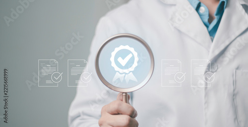 Medical insurance audit concept, claim assessment, quality assurance, compliance, certification, and healthcare protection. Doctor reviewing documents with a magnifying glass.
