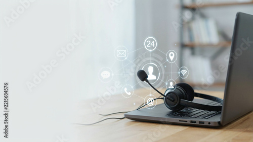 Headset on laptop with glowing communication icons representing customer service and digital connection