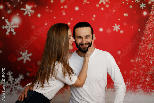 Romantic couple touching faces on Christmas background