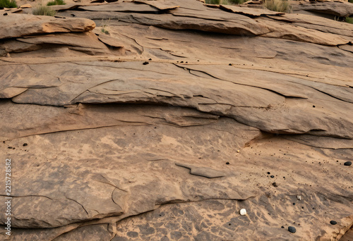 Geology and earth science background, layered sandstone rock formations with natural erosion patterns and desert textures in a rugged arid landscape