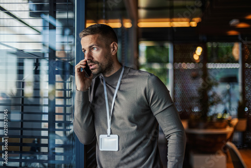 Employee having serious conversation on smartphone at office