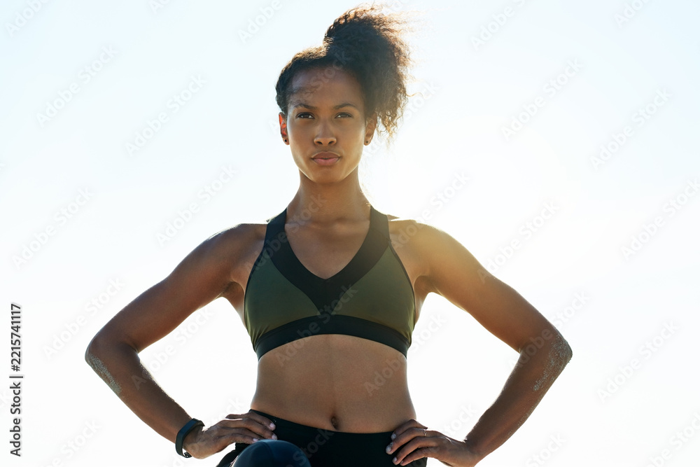 Naklejka premium Thinking, athlete and woman with confidence outdoor for fitness, exercise and training ideas. Blue sky, female person and space for sports workout, cardio reflection or planning for marathon practice