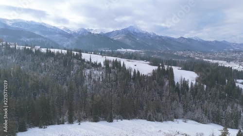 Winter aerial drone panorama of snowy Tatra Mountain ridge and coniferous evergreen forest near Zakopane Poland