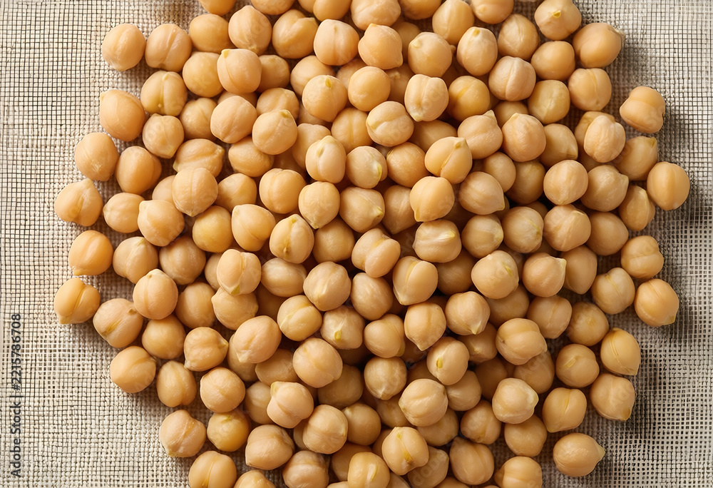 Fototapeta premium Healthy plant based protein, raw organic chickpeas for vegan nutrition and sustainable food sources on a textured linen background
