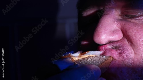 a man greedily eats snacks
