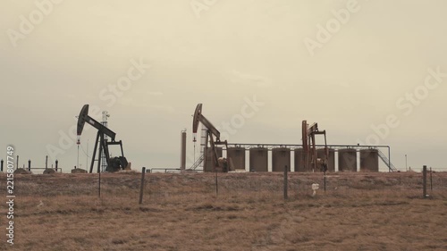 Oil pumps extracting crude fuel in a rural field