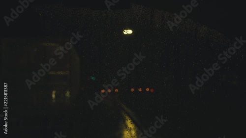 Driving car at night on a rainy street view