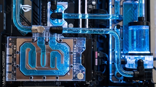 Custom liquid cooling system with blue coolant flowing through transparent tubing in a PC build